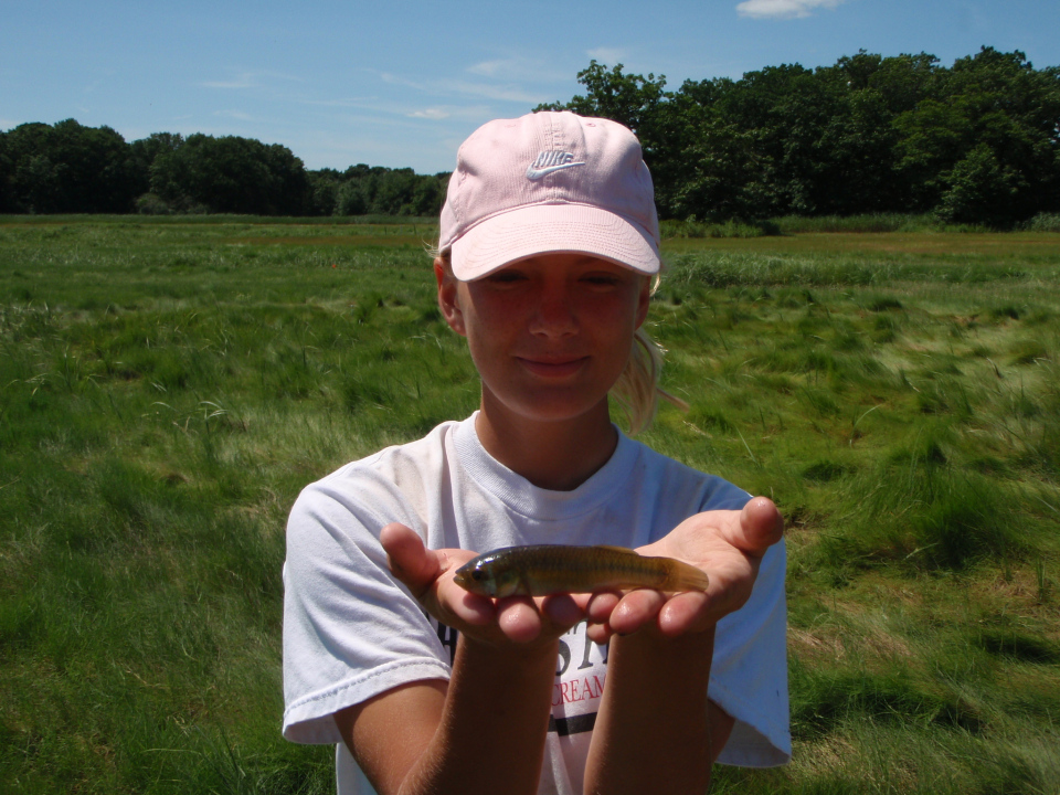 Talia Hughes holds a large mummichog