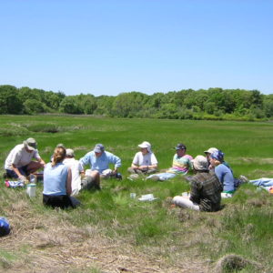 A meeting on the marsh, Sweeney Creek, in 2003.  John is out of the circle eating an orange.